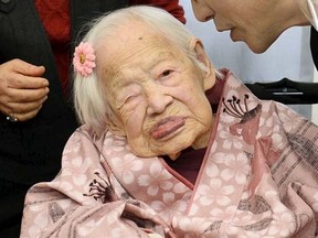 Misao Okawa, the world's oldest living person, celebrates with Takehiro Ogura (R), mayor of Osaka's Higashi-Sumiyoshi Ward, on the eve of her 117th birthday at an elder care facility in Osaka, western Japan in this file photo taken by Kyodo March 5, 2015. Okawa died in Osaka on April 1, 2015 early morning, Japanese local media reported. Mandatory Credit REUTERS/Kyodo/Files