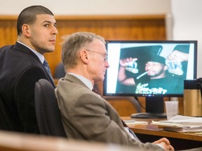Former New England Patriots tight end Aaron Hernandez listens next to his attorney Charles Rankin as a photo of witness Darryl Hodge, close friend of Odin Lloyd, is displayed during his murder trial at Bristol County Superior Court in Fall River, Massachusetts, March 31, 2015.  (REUTERS/Aram Boghosian/Pool)