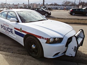 A police cruiser blocks the road after a collision between a pedestrian and a bicyclist occurred near 82 Street and 128A Avenue in Edmonton, Alta., on Tuesday, March 31, 2015. Codie McLachlan/Edmonton Sun/QMI Agency
