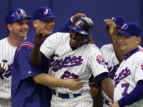 Montreal Expos' Vladimir Guerrero (C) is congratulated by teammates following his game-winning home run in the ninth inning of play against the Philadelphia Phillies at Olympic Stadium in Montreal, July 18, 2001. (REUTERS)