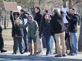 A group gathered outside the Sarnia Courthouse property this week to rally against what they called a lax approach to punishing people for writing false affidavits, when those come to light in court. About 10 people were on the sidewalk, but more were inside the courthouse, an organizer said. Photograph taken at Sarnia, Ont. on Monday, March 30, 2015. (TYLER KULA/ THE OBSERVER/ QMI AGENCY)