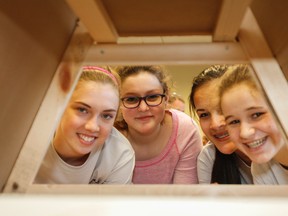 Rosie Riveter, the all girls team from Calvin Park Public School, Grace MacArthur, left, Lydia Beckwith, Gabby Coens and Clare Mouncey, look through their model home during the elementary construction challenge at the Limestone Skills Competition at St. Lawrence College. (Julia McKay/The Whig-Standard)