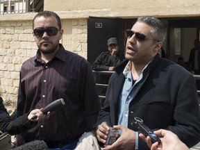 Al Jazeera television journalists Mohamed Fahmy (R) and Baher Mohamed speak to the media outside of a court in Cairo, March 19, 2015. 
REUTERS/Shadi Bushra