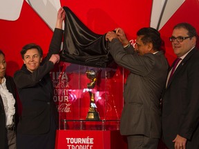 The Hon. Bal Gosal, Minister for Sport, unveils the Womans FIFA World Cup trophy at the Ottawa City Hall on April 1, 2015. Ottawa is the first of six cities to present the trophy throughout Canada. (Joel Watson/Ottawa Sun/QMI Agency)