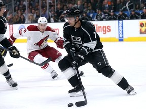 Andrej Sekera #7 of the Los Angeles Kings controls the puck in front of Lauri Korpikoski #28 of the Arizona Coyotes at Staples Center on March 16, 2015 in Los Angeles, California. The Kings won 1-0.  Stephen Dunn/Getty Images/AFP