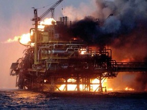 View of the Abkatun A-Permanente platform on fire on the Gulf of Mexico's Campeche Sound on April 1, 2015. An explosion and a fire erupted on an offshore oil platform operated by Mexico's Pemex on Wednesday, killing at least four workers, injuring 16 and forcing 300 to be evacuated.    AFP PHOTO/ STR