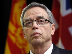 Canada's Finance Minister Joe Oliver listens to a question while speaking to journalists before the start of a meeting with his provincial and territorial counterparts in Ottawa December 15, 2014. Oliver said again on Monday he was confident the federal government would balance the budget next year, even given volatile oil prices. REUTERS/Chris Wattie