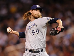 John Axford of the Milwaukee Brewers delivers a pitch against the Minnesota Twins during the ninth inning on June 15, 2012 at Target Field. (Hannah Foslien/Getty Images/AFP)