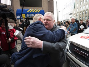 Councillor Rob Ford gets a hug from his brother Doug on Thursday April 2, 2015 after he announced doctors will operate on his tumour. (CRAIG ROBERTSON/Toronto Sun)