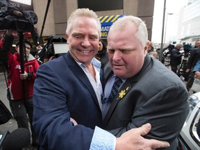 Councillor Rob Ford gets a hug from his brother Doug after announcing doctors will operate on his tumour in May on Thursday, April 2, 2015. (Craig Robertson/Toronto Sun)