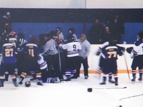 Referees try to breakup a brawl in which the Onaping Falls Huskies fought with the Mountain Blues during an Ontario minor hockey tournament this past weekend. (YouTube screen grab)