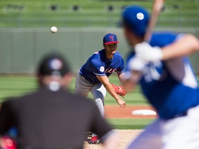 Texas Rangers pitcher Yu Darvish (11) pitches during the first inning during a spring training baseball game against the Kansas City Royals at Surprise Stadium. Mandatory Credit: Allan Henry-USA TODAY Sports