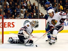 File photo of Chicago Blackhawks Nick Boynton (24) clearing the puck away from goalie Corey Crawford (50) during the first period of their NHL hockey game in Vancouver, British Columbia on November 20, 2010.  REUTERS/Ben Nelms/Files