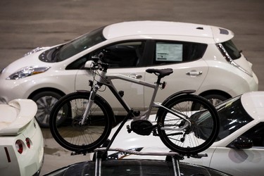A bicycle is seen on top of a BMW in the wash line during setup for the 2015 Edmonton Motorshow at Edmonton Expo Centre in Edmonton, Alta., on Thursday, April 2, 2015. The show runs from April 9 to 12, 2015. The Precious Metal Gala is on April 8 at 6:30 p.m. Ian Kucerak/Edmonton Sun/ QMI Agency