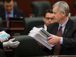 Alberta Finance Minister Robin Campbell with budget documents. (EDMONTON SUN/File)