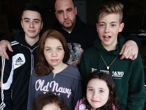 Thomas Sharpe with children Douglas, 15, Alexis, 11, Caylee, 5, Elizabeth, 8, and Brandon, 14, on Thursday, April 2, 2015. (Michael Peake/Toronto Sun)
