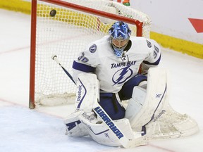 Tampa Bay Lightning goalie Ben Bishop turns aside a puck during second period action at the Canadian Tire Centre in Ottawa Thursday April 2,  2015. (Andrew Meade/Ottawa Sun/QMI Agency)