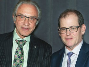 Paul Godfrey, president and CEO of Postmedia, receives the Ad Club of Toronto's Award of Merit from Toronto Sun Publisher Mike Power on Thursday, April 2, 2015 during Newspaper Day 2015. (Veronica Henri/Toronto Sun)