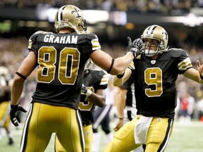New Orleans Saints quarterback Drew Brees celebrates with tight end Jimmy Graham after completing a touchdown pass against the Houston Texans during their NFL football game on September 25, 2011. (REUTERS/Sean Gardner)