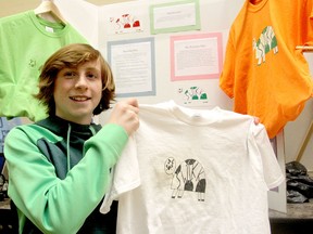 Finley Thompson, a Grade 7 student at La Salle Secondary School, shows a t-shirt logo he designed for his project on creating your own business, part of a showcase of projects conceived by the students themselves. THURS., APR 2, 2015.KINGSTON, ONT. MICHAEL LEA THE WHIG STANDARD QMI AGENCY