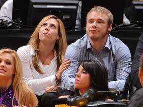 Los Angeles Kings player Dustin Brown and his wife Nicole attend a game between the Denver Nuggets and the Los Angeles Lakers.  Andrew D. Bernstein/AFP