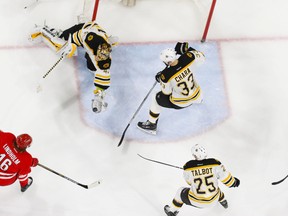 Boston Bruins goalie Tuukka Rask makes a glove save next to defencemen Zdeno Chara against the Carolina Hurricanes at PNC Arena on March 29, 2015. (James Guillory/USA TODAY Sports)