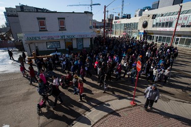 Hundreds of people cross through Chinatown during the 35th annual Outdoor Way of the Cross in Edmonton, Alta., on Friday, April 3, 2015. Organizers said 900 people participated in eight stations of the Cross, on Good Friday. Ian Kucerak/Edmonton Sun/ QMI Agency