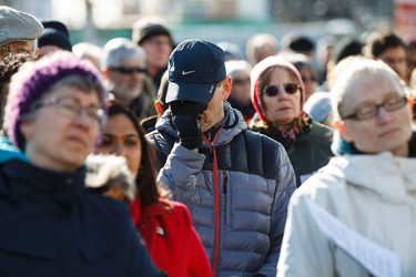 People listen and pray during the 35th annual Outdoor Way of the Cross in Edmonton, Alta., on Friday, April 3, 2015. Organizers said 900 people participated in eight stations of the Cross, on Good Friday. Ian Kucerak/Edmonton Sun/ QMI Agency