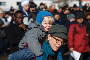 A mother and child participate in the 35th annual Outdoor Way of the Cross in Edmonton, Alta., on Friday, April 3, 2015. Organizers said 900 people participated in eight stations of the Cross, on Good Friday. Ian Kucerak/Edmonton Sun/ QMI Agency