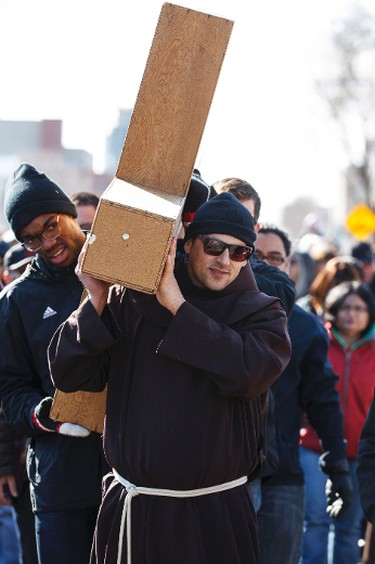 Friar Pierre Ducharme help carry the Cross during the 35th annual Outdoor Way of the Cross in Edmonton, Alta., on Friday, April 3, 2015. Organizers said 900 people participated in eight stations of the Cross, on Good Friday. Ian Kucerak/Edmonton Sun/ QMI Agency