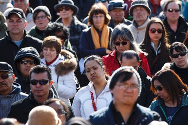 People take in singing and prayers in front of the Boyle McCauley Health Centre during the 35th annual Outdoor Way of the Cross in Edmonton, Alta., on Friday, April 3, 2015. Organizers said 900 people participated in eight stations of the Cross, on Good Friday. Ian Kucerak/Edmonton Sun/ QMI Agency
