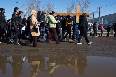 People carry the cross along 105 Avenue near 97 Street during the 35th annual Outdoor Way of the Cross in Edmonton, Alta., on Friday, April 3, 2015. Organizers said 900 people participated in eight stations of the Cross, on Good Friday. Ian Kucerak/Edmonton Sun/ QMI Agency