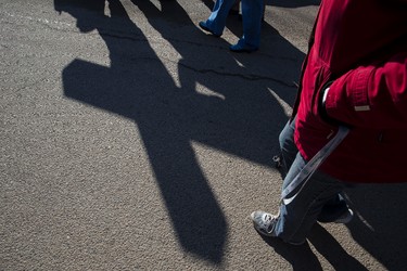 People march with the cross during the 35th annual Outdoor Way of the Cross in Edmonton, Alta., on Friday, April 3, 2015. Organizers said 900 people participated in eight stations of the Cross, on Good Friday. Ian Kucerak/Edmonton Sun/ QMI Agency