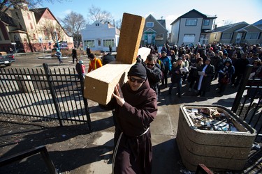 Friar Pierre Ducharme help carry the Cross during the 35th annual Outdoor Way of the Cross in Edmonton, Alta., on Friday, April 3, 2015. Organizers said 900 people participated in eight stations of the Cross, on Good Friday. Ian Kucerak/Edmonton Sun/ QMI Agency