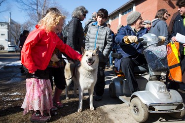 Sitka the dog walks with Yana (left), 8, Lily (centre), 8, and Josh, 10, to the McCauley Multicultural Centre during the 35th annual Outdoor Way of the Cross in Edmonton, Alta., on Friday, April 3, 2015. Organizers said 900 people participated in eight stations of the Cross, on Good Friday. Ian Kucerak/Edmonton Sun/ QMI Agency