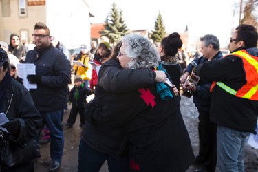 Sharon Pasula hugs a walker after speacking about justice and reconciliation between indigenous and settler peoples in front of Ambrose Place during the 35th annual Outdoor Way of the Cross in Edmonton, Alta., on Friday, April 3, 2015. Organizers said 900 people participated in eight stations of the Cross, on Good Friday. Ian Kucerak/Edmonton Sun/ QMI Agency