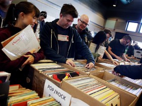 Shoppers sift through vinyl records at the Super Mega Records Garage Sale 2 at the Kenilworth Community Centre, 7104 87 Ave NW, on Friday April 3, 2015 in Edmonton, AB.  TREVOR ROBB/EDMONTON SUN/QMI AGENCY