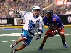 Cody Jamieson of the Rochester Nighthawks is guarded by Sandy Chapman of the Rock during NLL action at the Air Canada Centre on Friday night. (MICHAEL PEAKE/TORONTO SUN)