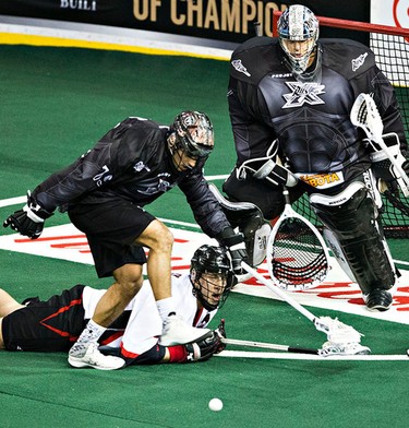 Edmonton's Nik Bilic foils an attempt by Vancouver's Tyler Digby during the Edmonton Rush's NLL lacrosse game against the Vancouver Stealth at Rexall Place in Edmonton, Alta., on Friday, April 3, 2015. Codie McLachlan/Edmonton Sun/QMI Agency