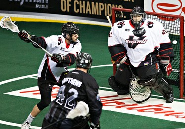 Edmonton's Mark Matthews takes a shot on Vancouver's Eric Penney during the Edmonton Rush's NLL lacrosse game against the Vancouver Stealth at Rexall Place in Edmonton, Alta., on Friday, April 3, 2015. Codie McLachlan/Edmonton Sun/QMI Agency