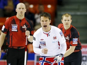 Norway's skip Thomas Ulsrud calls a shot in front of  Canada's lead Nolan Thiessen and second Carter Rycroft during their page playoff 1-2 match at the World Men's Curling Championships in Halifax, Nova Scotia.  (REUTERS/Mark Blinch)