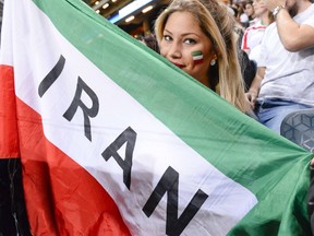 An Iranian supporter holds a flag during the friendly international football match between Sweden and Iran at the Friends Arena in Solna near Stockholm on March 31, 2015. (AFP PHOTO/JONATHAN NACKSTRAND)