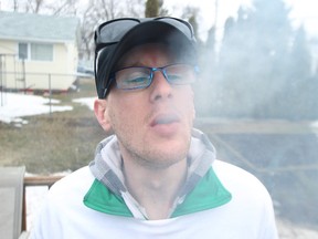 Medical marijuana user Steven Stairs smokes at his Winnipeg home on Sat., April 19, 2014. Stairs has organized a march prior to the 4/20 event at the Manitoba Legislative grounds on Sunday.