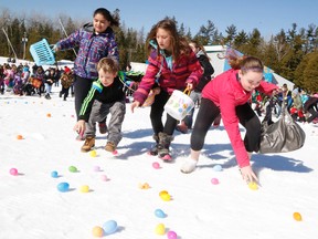 Kiley Kneilands leads a pack of racing youngsters in an attempt to get the most Easter eggs. Jason Miller/ The Intelligencer