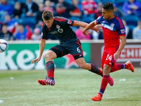 Toronto FC defender Nick Hagglund (6) and Chicago Fire forward Quincy Amarikwa (24) chase the ball during the first half at Toyota Park. (USA Today Sports)