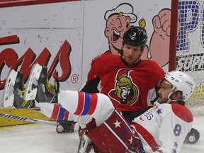 Ottawa Senators' Marc Methot hits Washington Capital's Alex Ovechkin during second period action at the Canadian Tire Centre in Ottawa Saturday, April 5,  2015.  Tony Caldwell/Ottawa Sun/QMI Agency