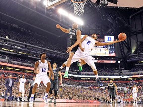 Duke guard Quinn Cook (2) lays the ball up against Marvin Clark Jr., of Michigan State during last night’s semifinal at Indianapolis. (ROBERT DEUTSCH, USA TODAY SPORTS)