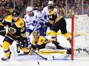 Torey Krug of the Boston Bruins clears the puck away from in front of goaltender Tuukka Rask during the second period as Maple Leafs forward Joffrey Lupul looks on at TD Garden last night. (Getty Images/AFP)