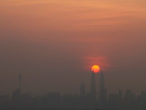 The skyline of Kuala Lumpur is seen covered with smog during sunset in the capital Malaysia July 4, 2011. REUTERS/Bazuki Muhammad