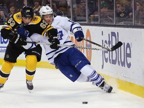 Bruins forward Brad Marchant (left) battles with Maple Leafs defenceman Jake Gardiner in Boston on Saturday night. (Getty Images/AFP)